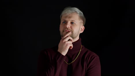 Thinking-man-looking-up-and-around-contemplating-how-to-solve-problem-against-black-background