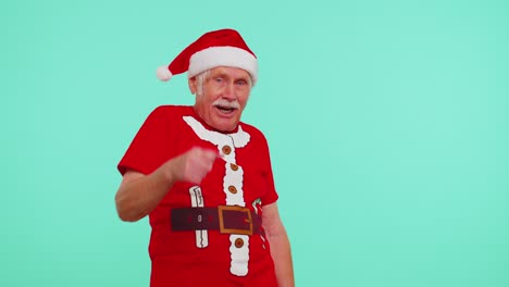 Senior-Christmas-grandfather-man-smiling-excitedly,-pointing-to-camera,-beauty-choosing-lucky-winner