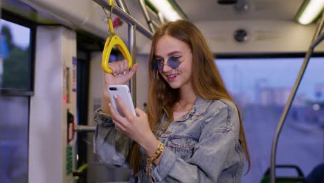 Woman-playing-on-smartphone,-chatting,-texting,-browsing-social-media-while-traveling-by-bus-to-city