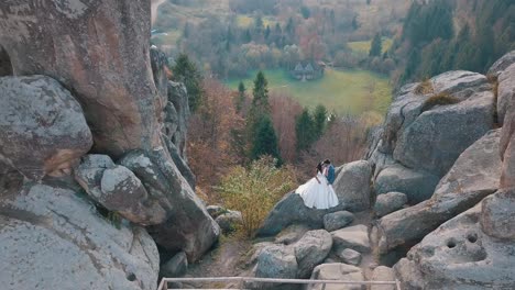 Los-Recién-Casados-Se-Encuentran-En-Una-Alta-Ladera-De-La-Montaña.-Novio-Y-Novia.-Vista-Aérea