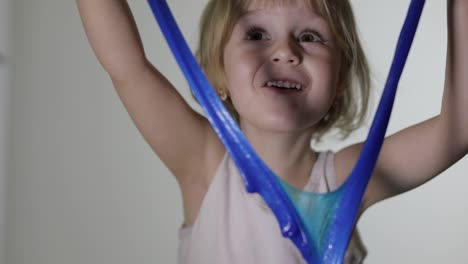 Child-having-fun-making-slime.-Kid-playing-with-hand-made-toy-slime.