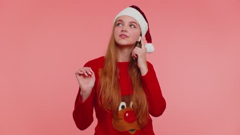 Woman-in-Christmas-sweater-listening-music-via-earphones,-dancing-disco-fooling-around-having-fun