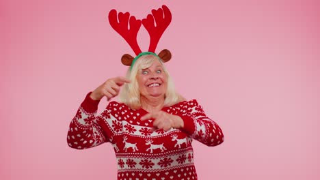 Crazy-senior-elderly-grandmother-woman-demonstrating-tongue-out,-fooling-around-making-silly-faces