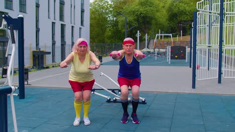 Senior-man-woman-doing-active-training-stretching-muscles-squatting-fitness-exercising-on-playground