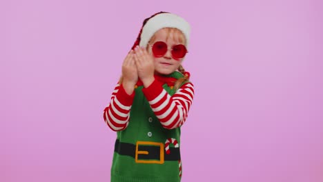 Girl-Christmas-Santa-Claus-Elf-listening-music-via-earphones-dancing-disco-fooling-around-having-fun