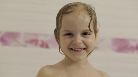 Attractive-three-years-old-girl-takes-a-bath.-Cleaning-and-washing-hair