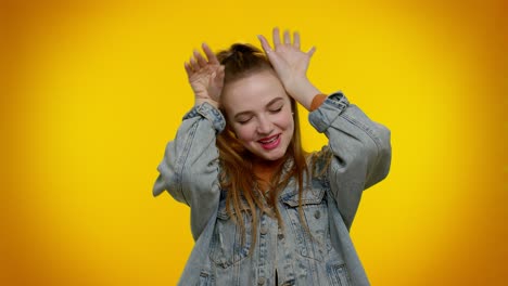 Lovely-funny-girl-smiling-friendly,-doing-bunny-ears-gesture-on-head-having-fun-fooling-comical-mood