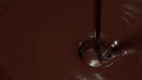 Pouring-premium-dark-melted-hot-chocolate,-process-of-making-confectionery-sweet-desserts,-icing