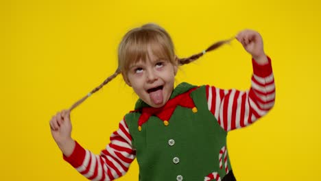 Kid-girl-in-Christmas-elf-Santa-helper-costume-dancing,-fooling-around.-New-Year-holiday-celebration