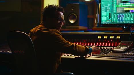 Portrait-of-african-american-sound-designer-mixing-and-mastering-tracks