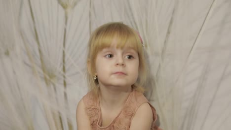 Happy-three-years-old-girl-make-faces-and-dancing.-Cute-blonde-child