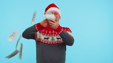 Rich-man-winner-in-Christmas-red-sweater-and-hat-showing-wasting,-throwing-money-around,-shopping