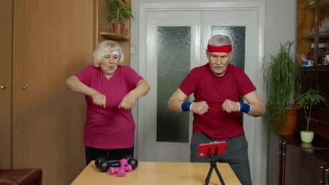 Mature-couple-man-and-woman-fitness-trainer-coach-records-video-online-workout-exercises-course