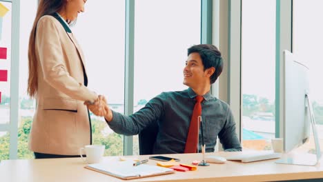 Business-people-handshake-with-friend-at-office