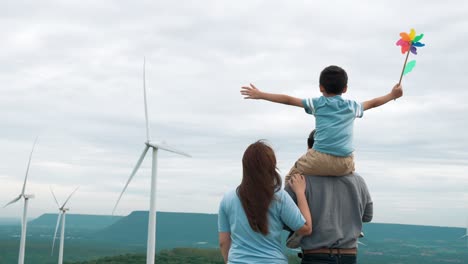 Concept-of-progressive-happy-family-enjoying-their-time-at-the-wind-turbine-farm