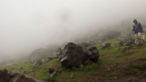 Walking-through-a-foggy-landscape-in-Iceland-with-large-rocks