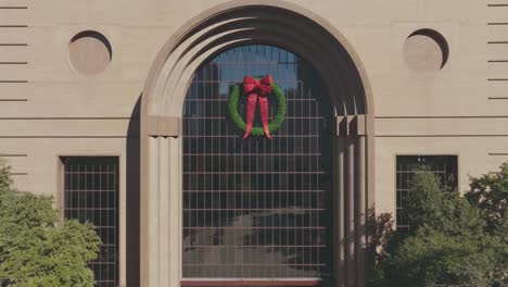 An-aerial-establishing-shot-of-the-Wortham-Theater-with-Christmas-decorations-in-the-Theater-District-in-downtown-Houston,-Texas