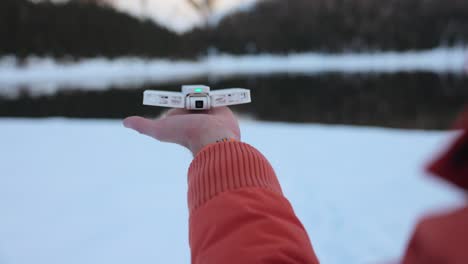 View-Of-Operator-Pressing-Button-On-Hoverair-X1-Pocket-Sized-Flying-Drone-On-Palm-Of-Hand-And-It-Flying-Off