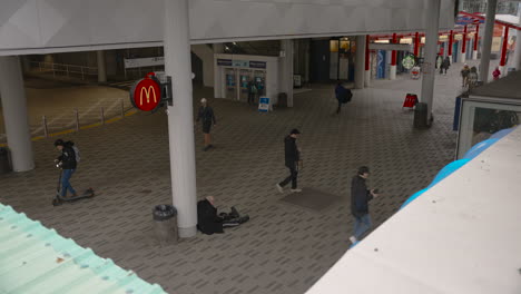 At-the-Lonsdale-Quay-SeaBus-Terminal-entrance,-people-milling-about,-seamlessly-moving-in-a-rhythmic-flow-of-arrivals-and-departures