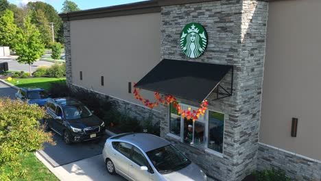 Starbucks-barista-is-handing-drive-through-customer-pink-refresher-drink