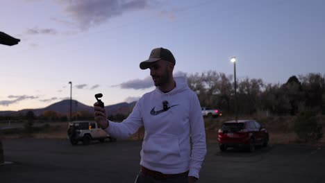 Man-Filming-Panoramic-View-Outdoor-At-Sunset-With-DJI-Osmo-Pocket-Camera