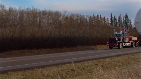 Slow-motion-footage-of-a-heavy,-over-sized-load-being-transported-by-Mammoet-Heavy-Transport-to-the-oilsands-oof-Fort-McMurray,-AB