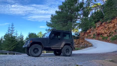 Cool-black-Jeep-4x4-car-with-nature-and-green-forest-view-around-on-Sierra-Bermeja-mountain,-fun-ATV-adventures-on-a-sunny-day-in-Marbella-Malaga-Spain,-4K-shot