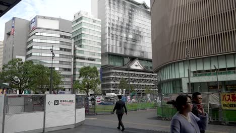 Bauzäune,-Geländer-Vor-Dem-Namba-Bahnhof-Mit-Menschen,-Die-In-Osaka-Vorbeigehen