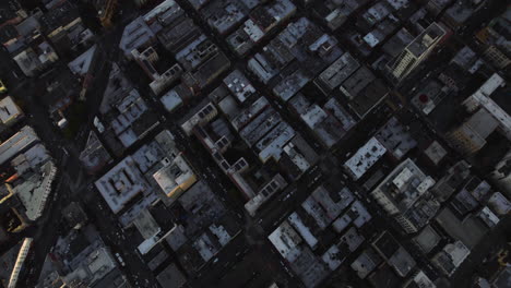 Aerial-tilt-shot-revealing-high-rise-in-downtown-San-Francisco-sunny-evening-in-USA