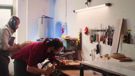 Woodworker-using-bench-vise-to-hold-lumber-block,-carving-intricate-designs