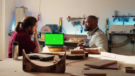 Joyous-cabinetmaker-look-over-blueprints-schematics-on-isolated-screen-laptop