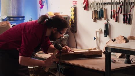 Woodworker-using-bench-vise-to-hold-lumber-block,-carving-intricate-designs