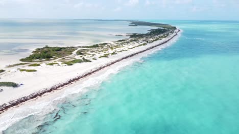 Aerial-of-Isla-Blanca,-Mexico,-perpetual-ebb-and-flow-of-the-ocean