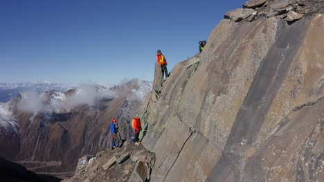 Escaladores-Liberando-El-Camino-De-Rocas-Sueltas-En-Una-Pared-Vertical-En-Las-Altas-Montañas-Del-Tíbet