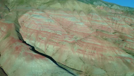 Petra,-Jordan,-Middle-East-aerial-view-in-top-angle-drone-camera-moving-upwards-where-hills-and-mountains-are-visible