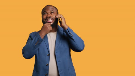 Man-having-thoughtful-conversation-with-friend-during-telephone-call