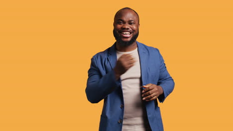 Portrait-of-joyful-man-celebrating,-studio-background