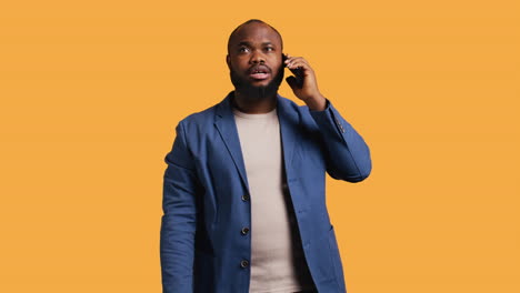 Happy-person-with-smile-on-face-during-telephone-call,-studio-background