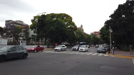 Buses-and-Cars-Drive-Ganoa-Avenue-in-Caballito-Buenos-Aires-Argentina-City-Park-Irlanda,-Public-Transportation