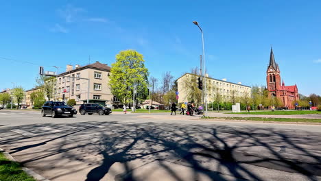 Street-of-Jelgava-city-with-living-buildings-and-church,-time-lapse-view