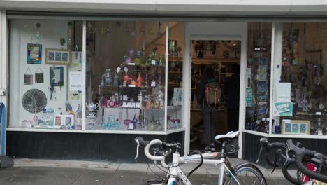 Woman-with-a-bag-enters-souvenir-shop