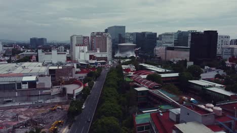 Panoramic-track-shot-of-Soumaya-Museum-and-surroundings-in-Polanco,-Mexico-City-in-a-cloudy-day