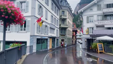 Interlaken-Switzerland-Immersive-Travel-Tourism-Mountainside-Valley-Resort-City,-Europe,-Walking,-Rainy-Day,-4K-|-Looking-Around,-Shaky,-Water,-River,-Lake,-Restaurant,-Flower,-Bridge,-Spin,-Road