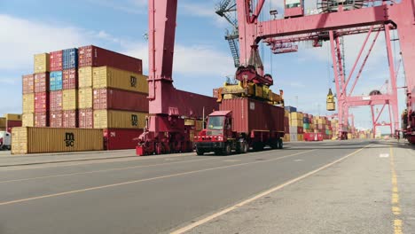 Port-of-Montreal-crane-loading-storage-container-onto-trailer-truck-for-haulage