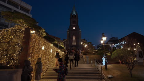 People-walking-up-the-steps-towards-Myeongdong-Cathedral-at-night-Seoul