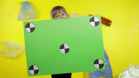 Girl-activist-holding-chroma-key-poster-with-tracking-points.-Environment-trash-plastic-pollution