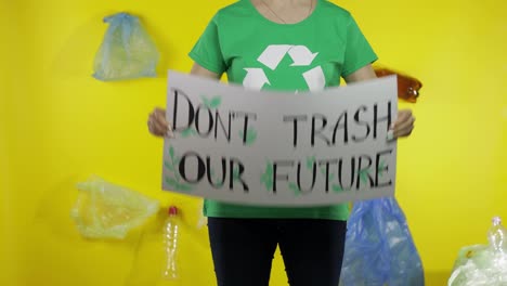 Unrecognizable-woman-holding-protesting-poster-Don't-Trash-Our-Future.-Environment-plastic-pollution