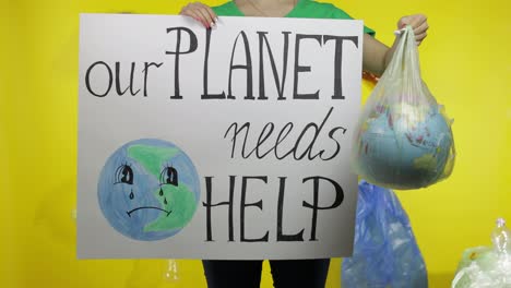 Unrecognizable-woman-with-protesting-poster-and-Earth-globe-in-plastic-package.-Ecology-pollution