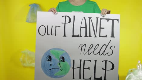 Unrecognizable-woman-holding-protesting-poster-Our-Planet-Needs-Help.-Environment-plastic-pollution