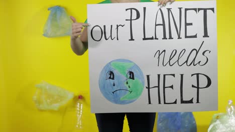 Unrecognizable-woman-holding-protesting-poster-Our-Planet-Needs-Help.-Environment-plastic-pollution